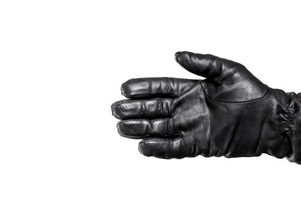 istock Open hand in black leather glove isolated on white. Hello hand gesture. Palm hand in black leather. 1947308026