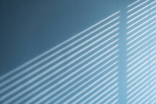 istock light and shadow of blind form the window on the concrete wall 1947308179