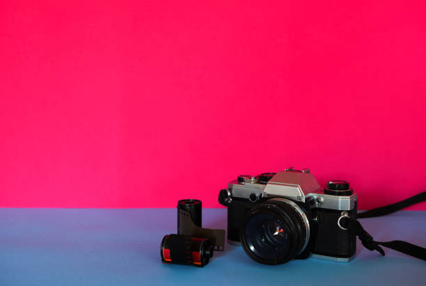 istock 35mm camera with rolls of film 1947346532