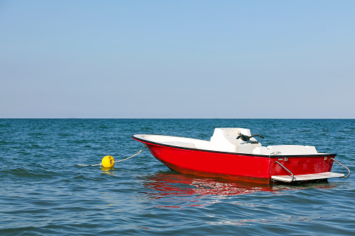 red speedboat in the sea to carry out the rescue of the bathers who are drowning