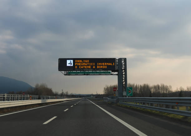 istock motorway sign indicating that it is mandatory to have snow chains and that there is an automatic speed detection system in Italy 1947365884