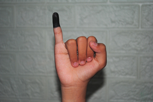 People who have voted in the Indonesian election are required to dip one of their fingers as proof of completion.