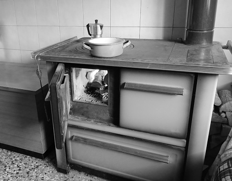 wood stove of a cheap kitchen with moka to make coffee in white and black effect