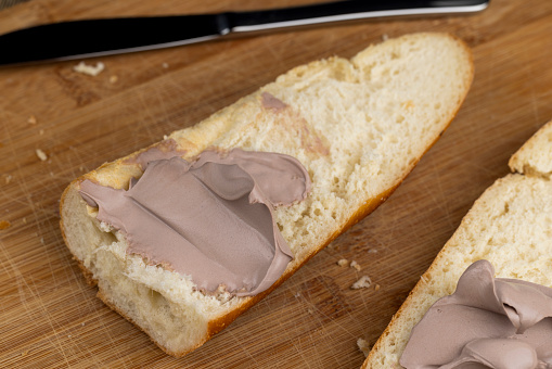 cream cheese with added cocoa on a baguette, making a sandwich with chocolate-flavored cheese