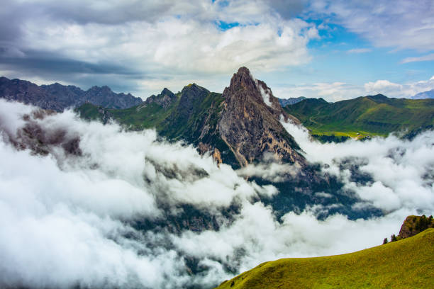 Summer time in Dolomites. landscape with mountains, hills and clouds.