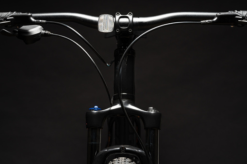 Close up photo of a bicycle against black background