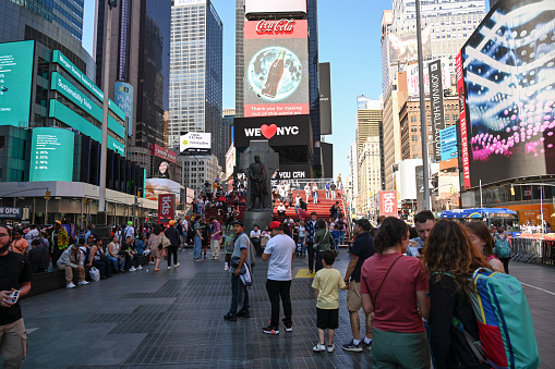 New York City, New York, USA, April 12, 2023 - Tourists and locals at Father Duffy Square in the northern triangle of Times Square in Midtown Manhattan, New York.