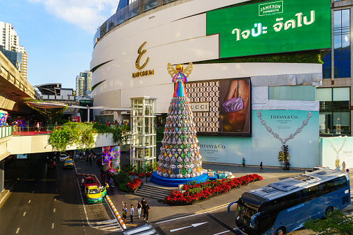 Bangkok, Thailand - December 31, 2023: Decorating a large Christmas tree in front of Emporium, a famous department store on Sukhumvit Road, The last day of 2023 before the start of the new year 2024.