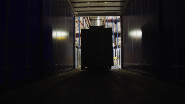 Forklift Loading Merchandise in the Semi Trailer