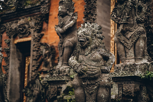 Ubud temple decorative stone statues. Balinese religious sacred architecture, stone curved sculptures