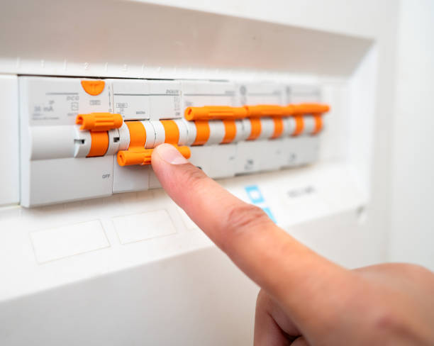 istock man turning off the fusebox 1947466530
