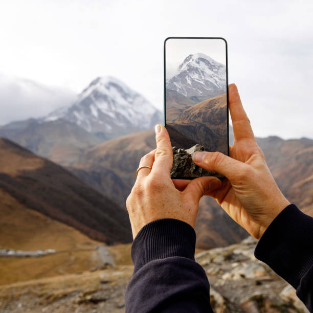 istock Hiker Holding Smartphone in Mountain Landscape 1947466886