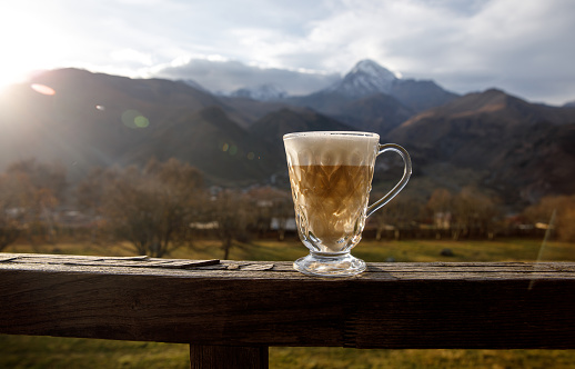 Cup of cappuccino with mountain background