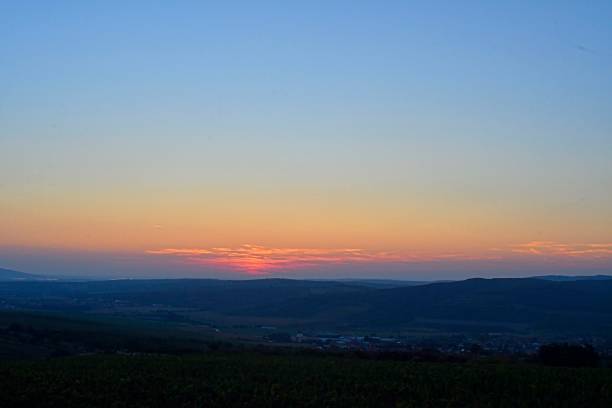 Landscape at twilight with red sky. Romantic sunset with red clouds. Countryside during the blush of dawn.