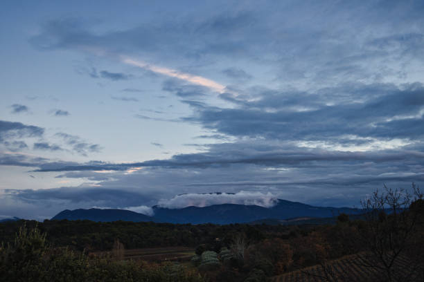 Piegon, France - December 1, 2024. View of the famous Mont Ventoux, giant of Provence, whose summit is licked by winter clouds.