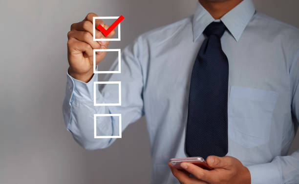 istock checklist concept businessman check mark on check box with check mark. 1947491423