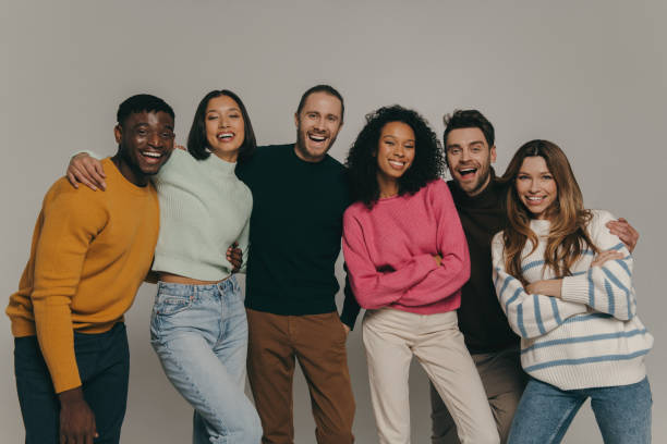 istock Joyful young people bonding and smiling while standing on beige background together 1947507608