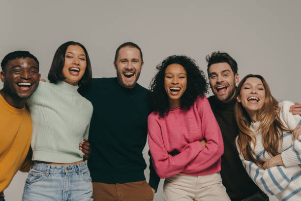 istock Joyful young people bonding and smiling while standing on beige background together 1947507609
