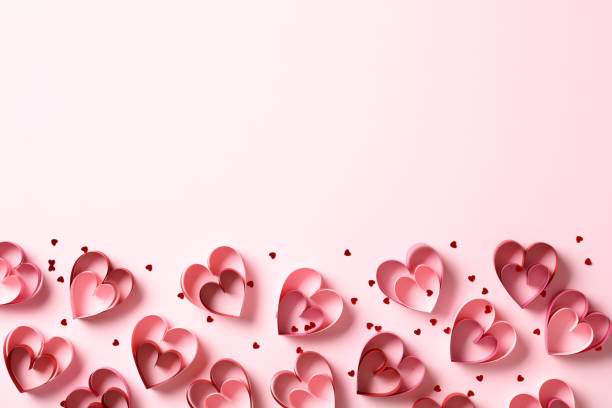 istock Valentine's Day flat lay composition with paper cut hearts and confetti on pink background. Top view. 1947517385