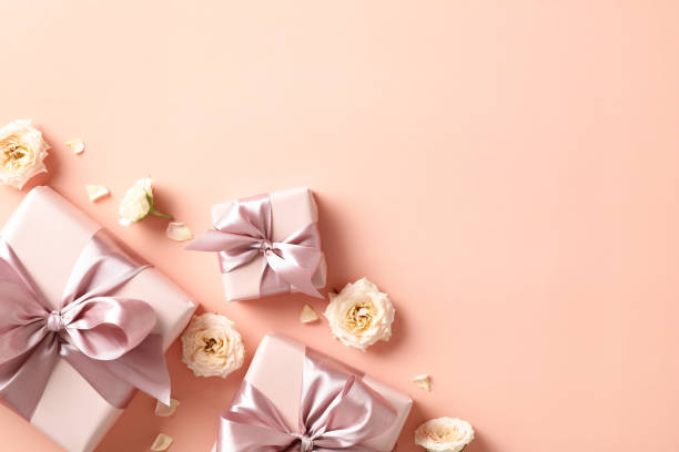 istock Flat lay composition with gift boxes, roses buds on pastel beige background. Valentines Day, love, romance concept 1947520250