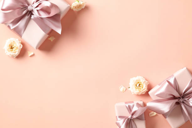 istock Valentine's Day card design with gift boxes and roses on pastel beige background. Flat lay, top view, copy space. 1947520899