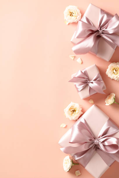 istock Valentines Day poster design. Flat lay composition with gift boxes and roses buds on beige background. 1947521423
