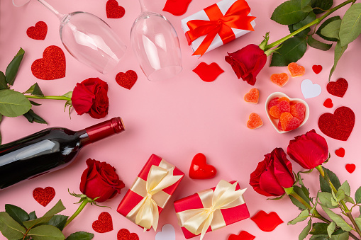 Valentine's Day concept. Valentine's Day background. Gifts, candles, confetti, envelope - postcard on  background. Flatley, top view, copy space.Valentine's day celebration