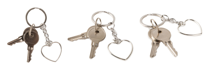 CLOSE UP OF KEY AND HOUSE KEYCHAIN ​​IN HIGH SECURITY DOOR LOCK. HOME INSURANCE CONCEPT. COPY SPACE.