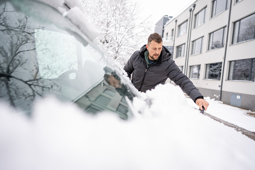 Cleaning off a snowy vehicle