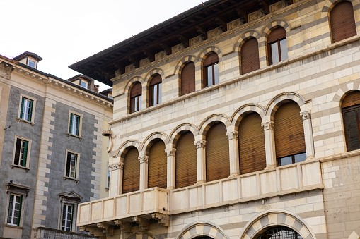 Como, Italy, historic city architecture. A building with the characteristic facade and windows. Summer time
