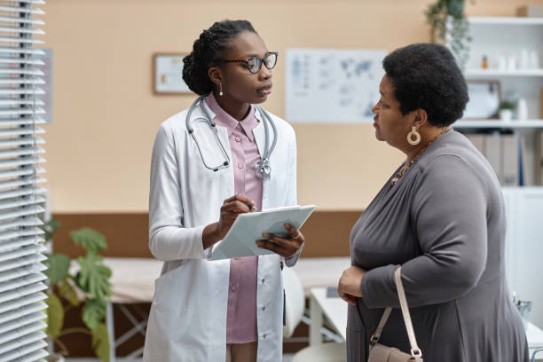 istock Doctor Questioning Patient in Clinic 1947527003