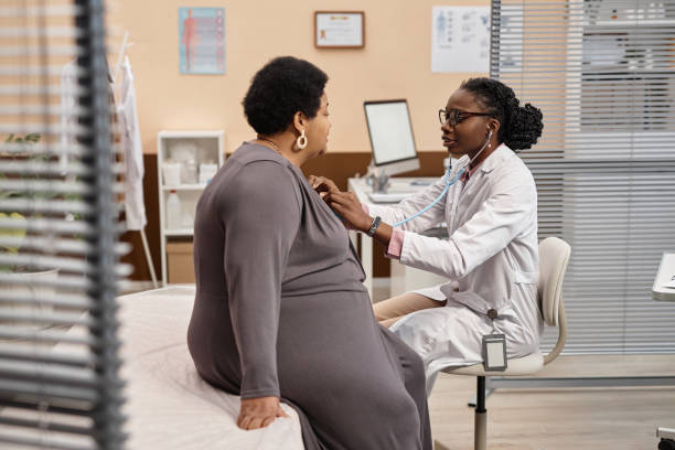 istock Female General Practitioner Using Stethoscope with Patient in Clinic 1947527545