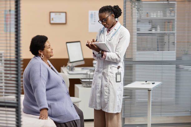 istock Smiling Patient at Check up with Health Practitioner 1947527552