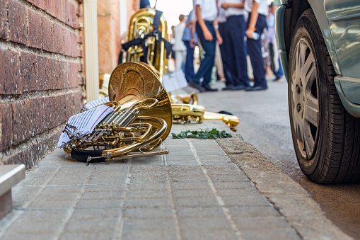 Castilla La Mancha, Spain. Wind instruments and sheet music on the sidewalk of a Manchegan town square during a break of the local music band.