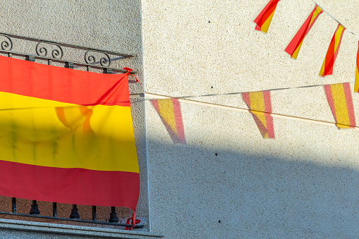 Castilla La Mancha, Spain. Village patron saint festivals. Colorful bunting hanging on the facades of houses.