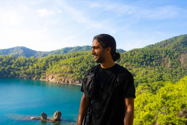 A man hiking looks at the landscape on a nature walk