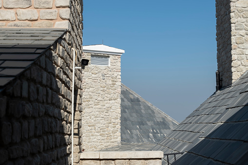 The slate-covered house wall of an old, winding residential building