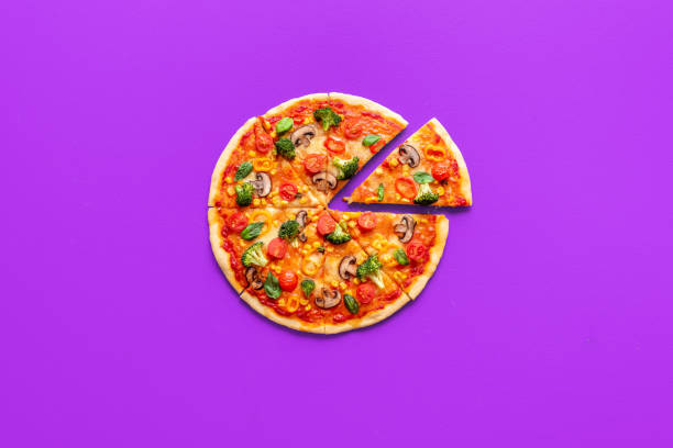 istock Vegan pizza top view, isolated on a purple background 1947649659