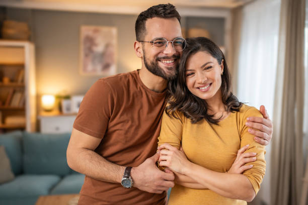 istock Young couple embracing at home 1947667203