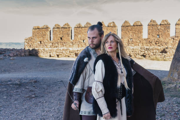 istock Noble Medieval Pair by Ancient Fortress Ruins 1947717482