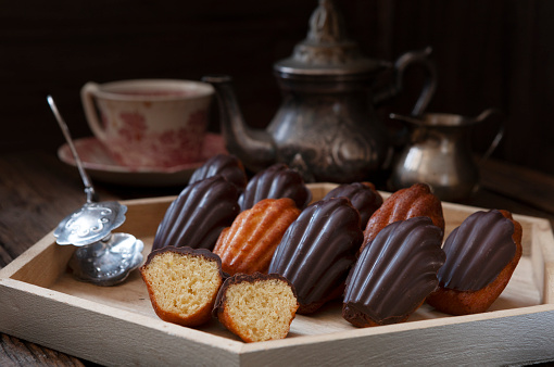 Traditional homemade classic biscuit French Madeleine lemon cookies in chocolate glaze