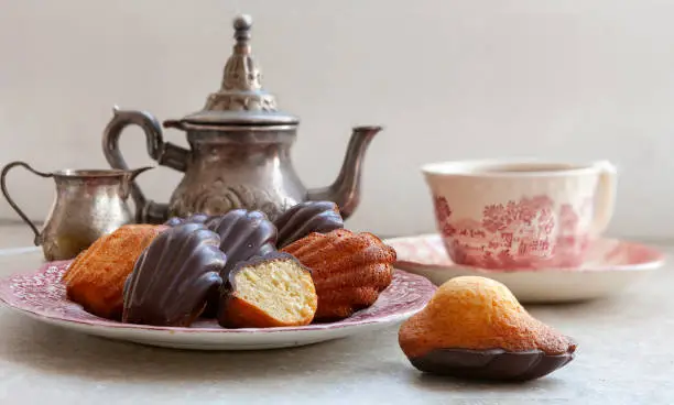 Traditional homemade classic biscuit French Madeleine lemon cookies in chocolate glaze