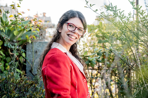 Portrait of a young woman with down syndrome on apartment's balcony