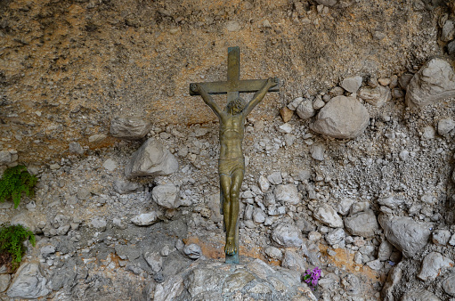 metal cross stuck in a rock in a sanctuary near Makarska