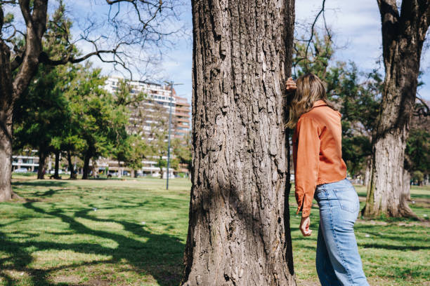 istock Woman playing hide and seek at the park 1947793788
