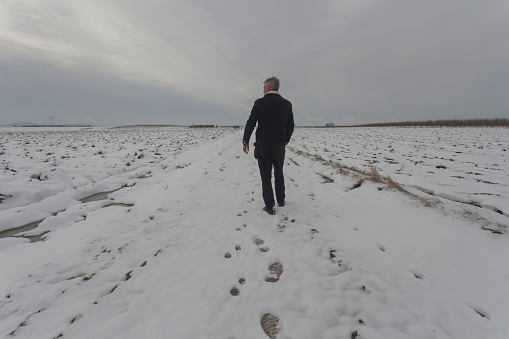 Small business farm in winter. Frozen plowed fields covered with snow.