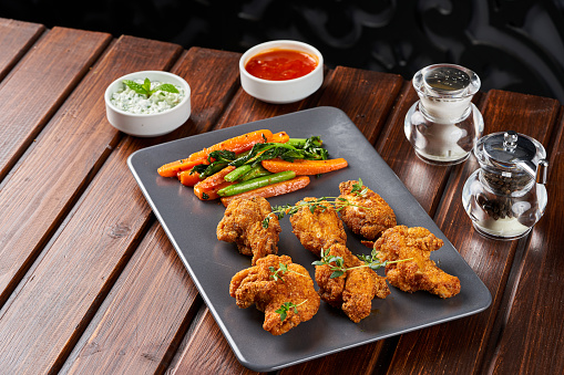 Fried chicken wings dish with vegetables