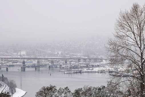 The Ironworkers Memorial Second Narrows Crossing connecting Vancouver to the North Shore in the Burrard Inlet as seen from Capitol Hill during a snowy winter season in Burnaby, British Columbia, Canada.