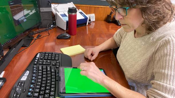 istock Senior woman working from home office on devises 1947892292