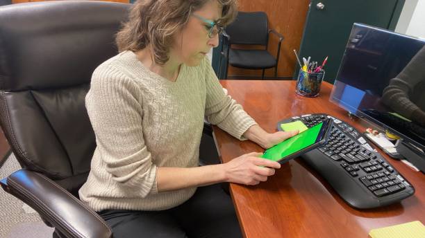 istock Senior woman working from home office on devises 1947892303